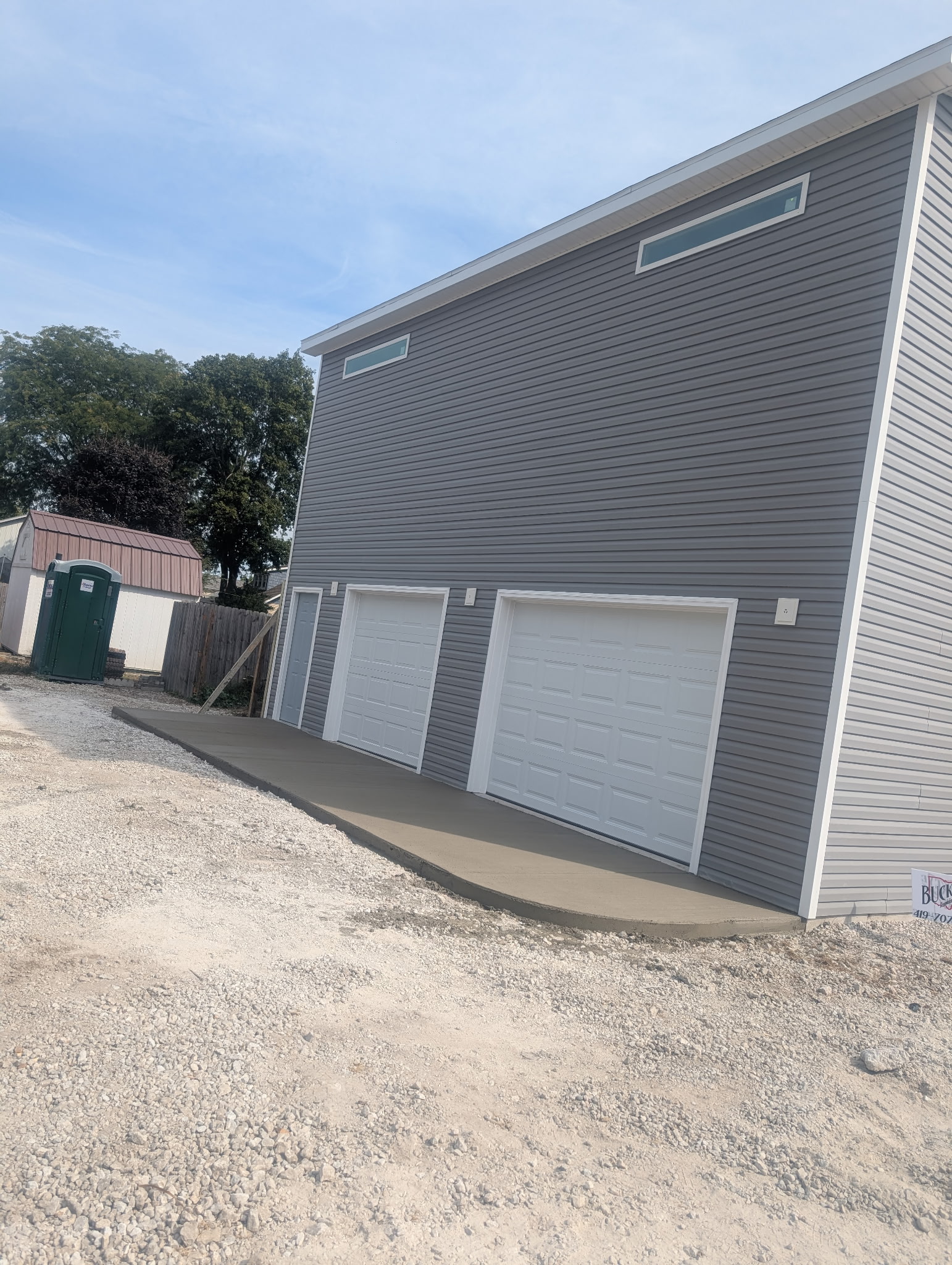 Side view of the concrete apron at a two-door garage.