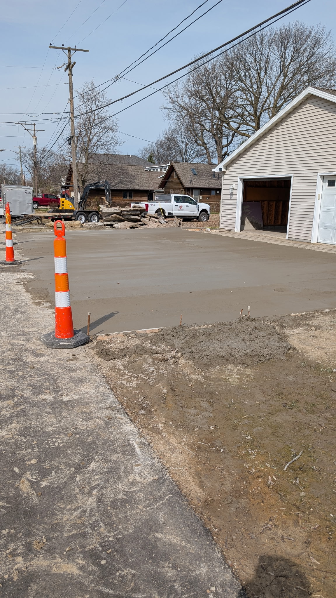 Fresh concrete placement in front of a detached garage.