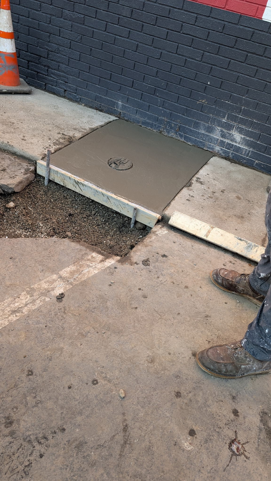Small concrete replacement panel in forms beside existing concrete.